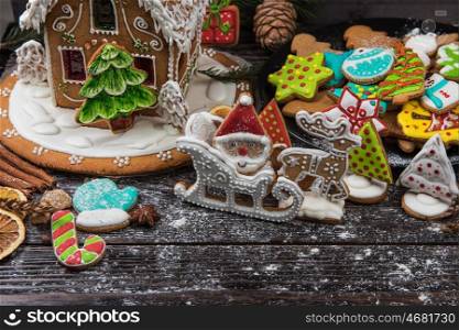 Homemade gingerbreads for new years and christmas on wooden background, xmas theme