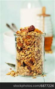 Homemade granola on rustic table. Healthy breakfast of oatmeal, muesli, nuts, seeds and dried fruit.