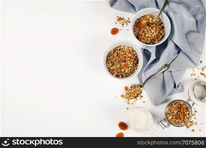 Homemade granola (with dried fruit and nuts) on white background