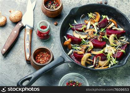 Homemade grilled salad with beets, mushrooms and microgreens in a pan. Grilled salad with beets and mushrooms