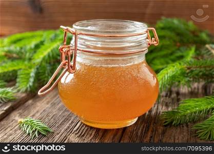 Homemade herbal syrup against cough made from young spruce tips in a jar