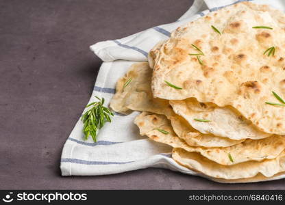 Homemade hot chapati on kitchen countertop background.