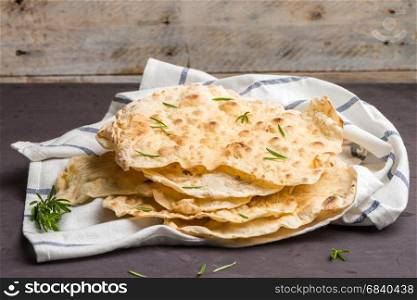 Homemade hot chapati on kitchen countertop background.