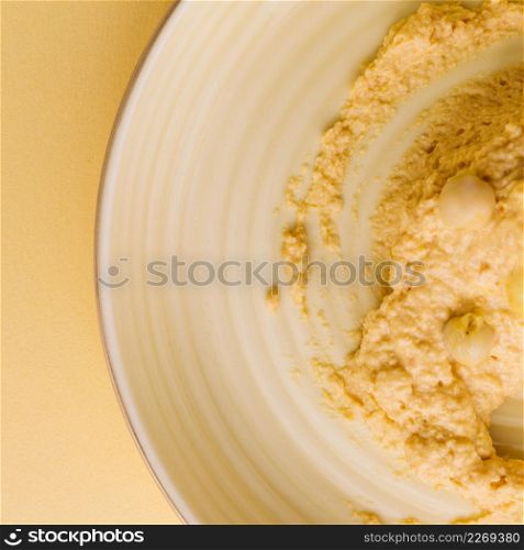 homemade hummus with chickpea plate against beige background