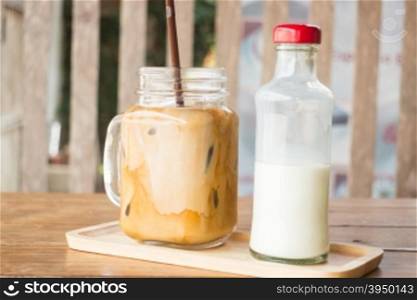 Homemade iced coffee latte on wooden table, stock photo