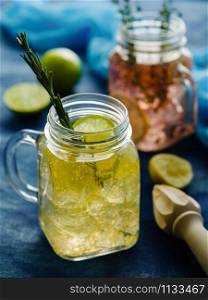 Homemade Iced fizzy Sparkling lemonade with lemon, rosemary and thyme in Mason jar