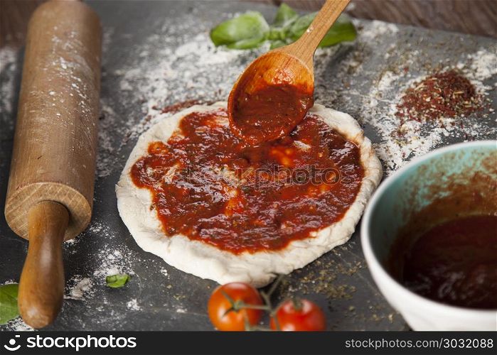 Homemade italian pizza preparation. Fresh an tasty homemade pizza preparation