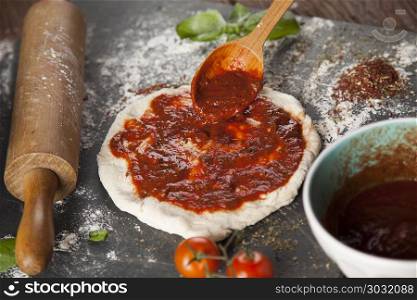 Homemade italian pizza preparation. Fresh an tasty homemade pizza preparation