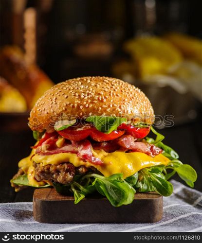 Homemade juicy burger with beef, bacon, cheese and bulgarian pepper. Street food, fast food.