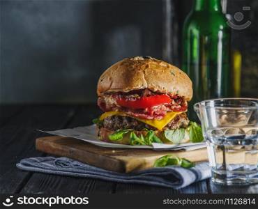 Homemade juicy burger with beef, bacon, cheese and bulgarian pepper. Street food, fast food.