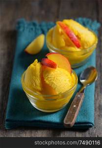 Homemade mango ice sorbet with peach slices