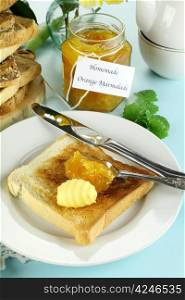 Homemade marmalade on toast with butter ready to serve.