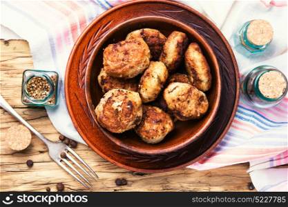 homemade meat cutlets. homemade cutlets in clay dish on rustic background