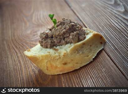 homemade meat snack chicken liver pate with bread on wooden table