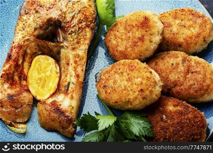 Homemade minced fish cutlets and fish steak. Minced fish cutlets