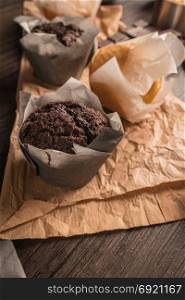 Homemade muffins with chocolate and baking ingredients.