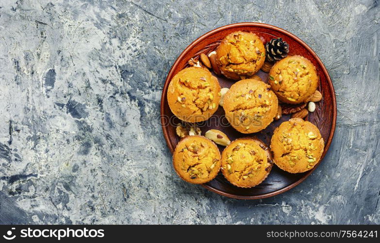 Homemade muffins with nuts on a plate.. Fragrant homemade cakes, muffins.