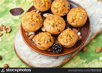Homemade muffins with nuts on a plate.. Homemade muffins with nuts