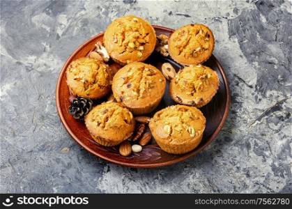 Homemade muffins with nuts on a plate.. Homemade muffins with nuts