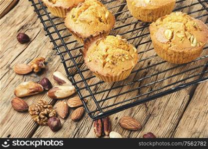 Homemade muffins with nuts on old wooden table. Homemade muffins with nuts