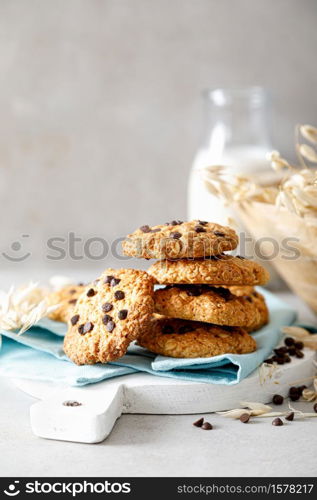 Homemade oatmeal cookies with chocolate drops and milk for breakfast