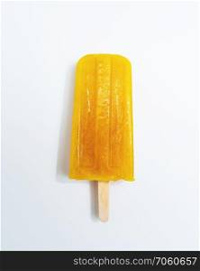 Homemade orange ice lolly sorbet on white background with space for text. The concept of healthy dietary dessert. Top view. Ice lollies. Orange fruit ice cream presented on a white background with copy space. Top view