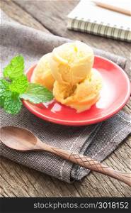 Homemade organic mango ice cream on red plate, Summer lifestyle