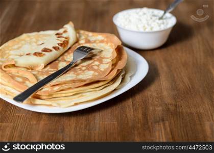 homemade pancakes on a white plate with cottage cheese