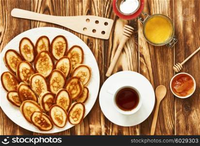 Homemade pancakes or fritters on wooden background