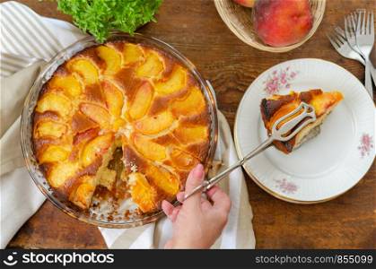Homemade peach cake ready to serve and on table, top view,