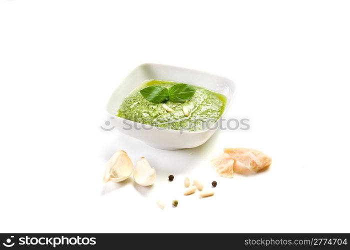 homemade pesto sauce on white background with garlic and parmesan