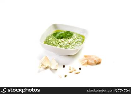 homemade pesto sauce on white background with garlic and parmesan