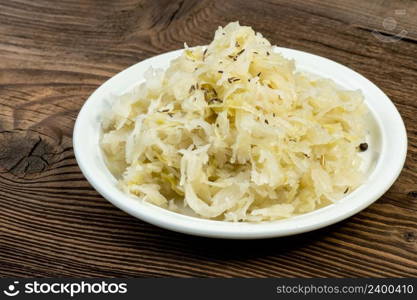 Homemade pickled sauerkraut on a white plate