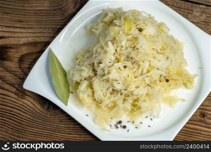 Homemade pickled sauerkraut on a white plate
