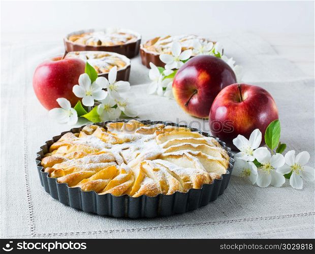 Homemade pie with red apples and apple tree branch, close up.. Homemade pie with red apples close up