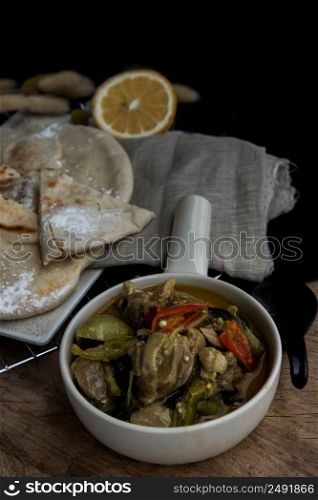 Homemade pita bread served with Green curry chicken (Kaeng khiao wan). Muslim food, No focus, specifically.