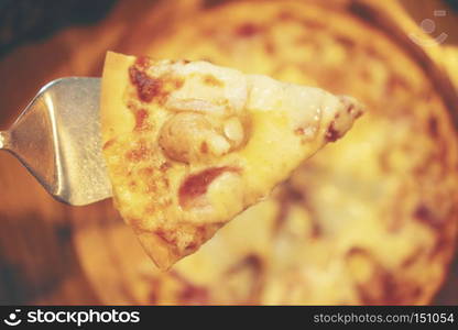 Homemade Pizza on a rustic wooden table.