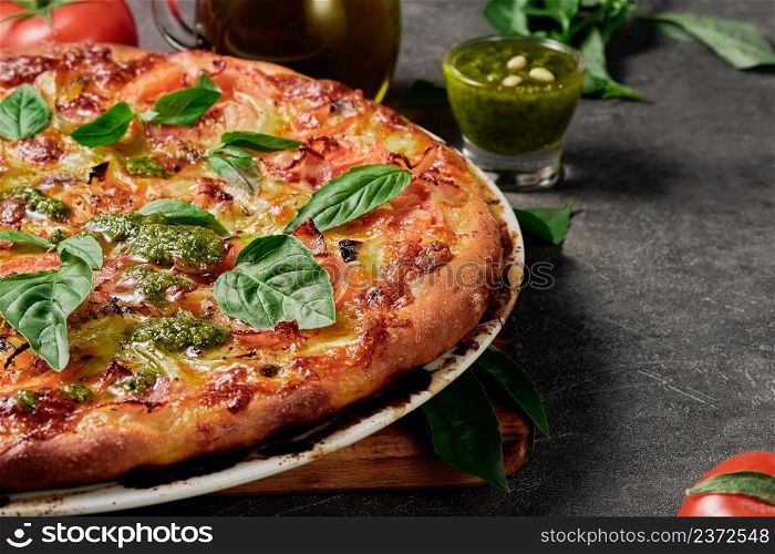 Homemade pizza. Traditional rustic Italian pizza with green basil pesto, close-up, selective focus. Pizza delivery, menu idea