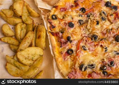 Homemade pizza with french fries on a wooden table