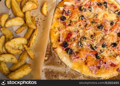 Homemade pizza with french fries on a wooden table
