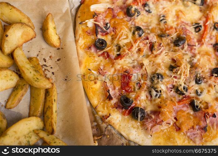 Homemade pizza with french fries on a wooden table. pizza