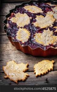 Homemade plum pie. Autumn pie with plum decorated cakes in the form of leaflets