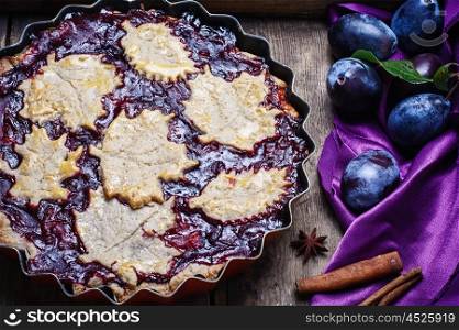 Homemade plum pie. Autumn pie with plum decorated cakes in the form of leaflets