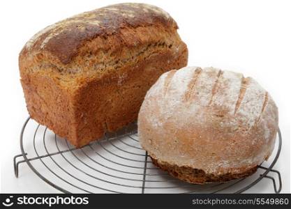 Homemade Polish rye bread (foreground) and an English wholemeal brown tin loaf