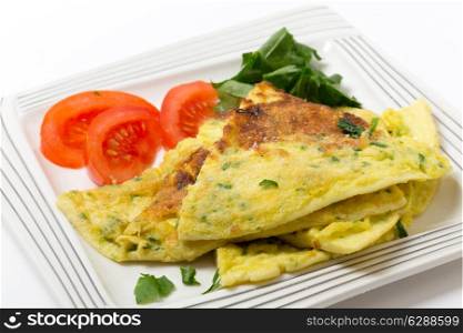 Homemade potato and parmesan cheese frittata omelet, with tomato and rocket, from an Italian recipe