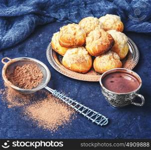 Homemade profiteroles dessert and cup hot chocolate