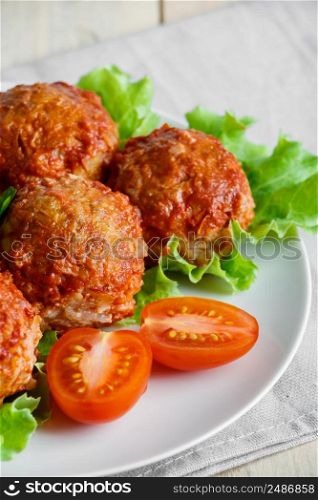 Homemade protein meat balls with vegetables in tomato sauce. Appetizing hot dish on a white plate.. Homemade protein meat balls with vegetables in tomato sauce. Appetizing hot dish on a plate.