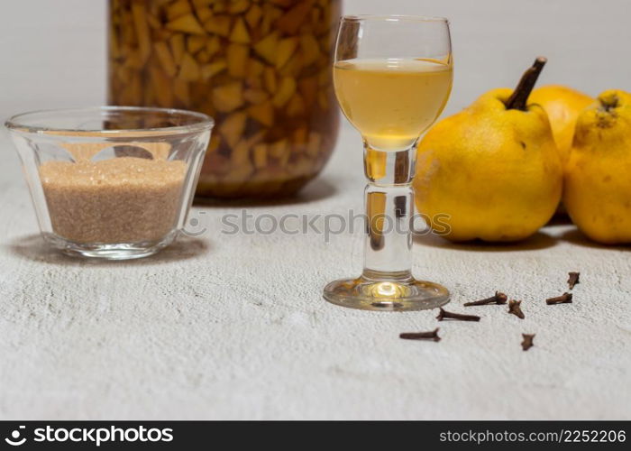 Homemade quince liqueur. Maceration of quinces in water, cane sugar, cinnamon, cloves and alcohol.