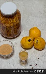 Homemade quince liqueur. Maceration of quinces in water, cane sugar, cinnamon, cloves and alcohol.