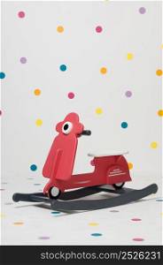 homemade red children&rsquo;s toy motorcycle on a white background. children&rsquo;s toy motorcycle